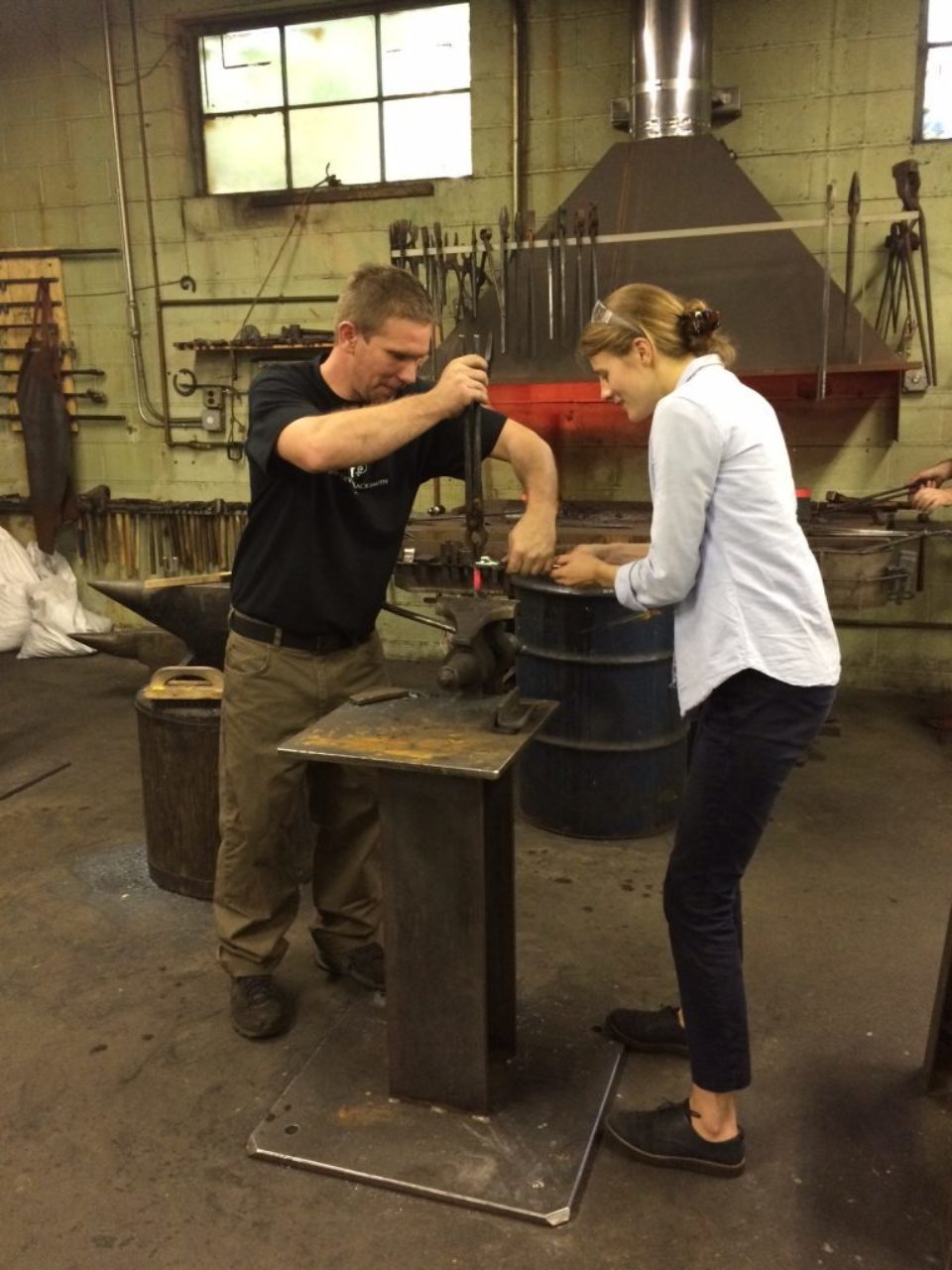 Covax Atelier blacksmith teaches Elaine Rose how to twist iron.