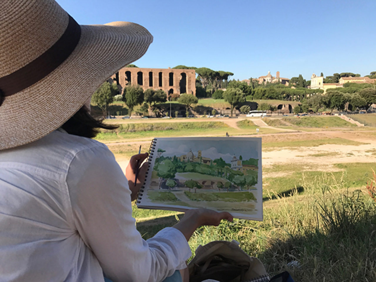 Tour participants sketch on location at Circus Maximus, overlooking Palatine Hill