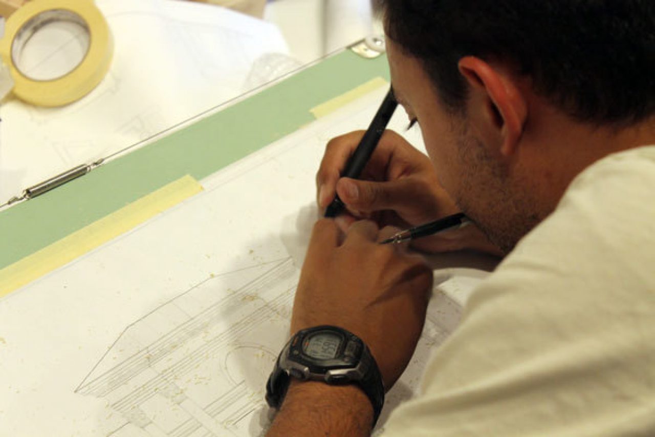 A student works on his final design for the Summer Studio