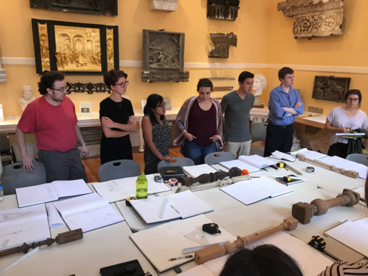 Students in the ICAA’s Cast Hall look over each other’s work at the end of the lesson