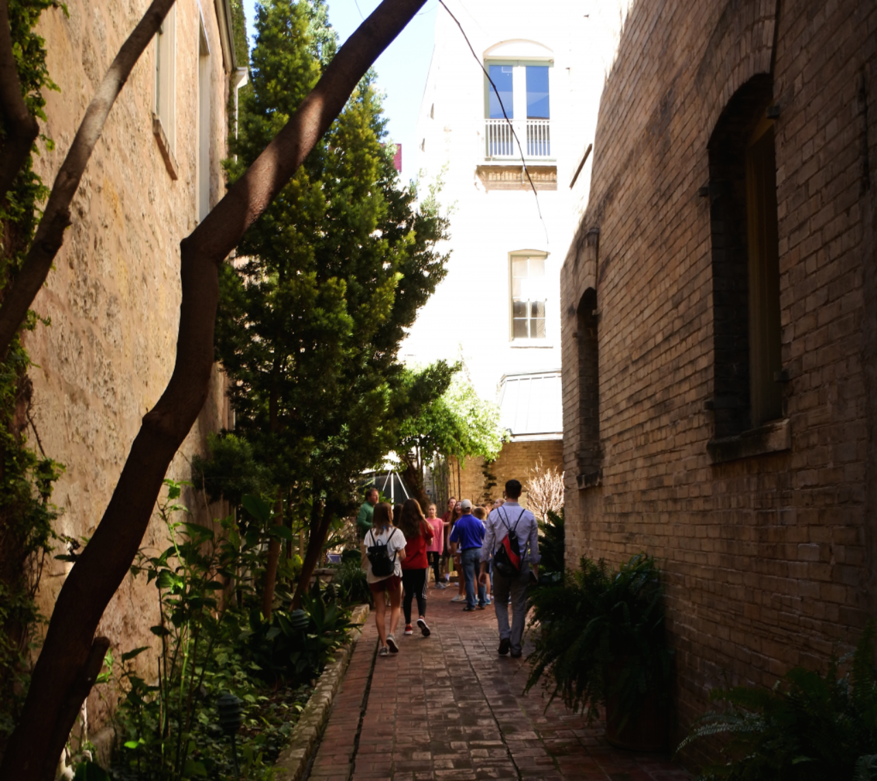 Mac White leads a walking tour into a courtyard