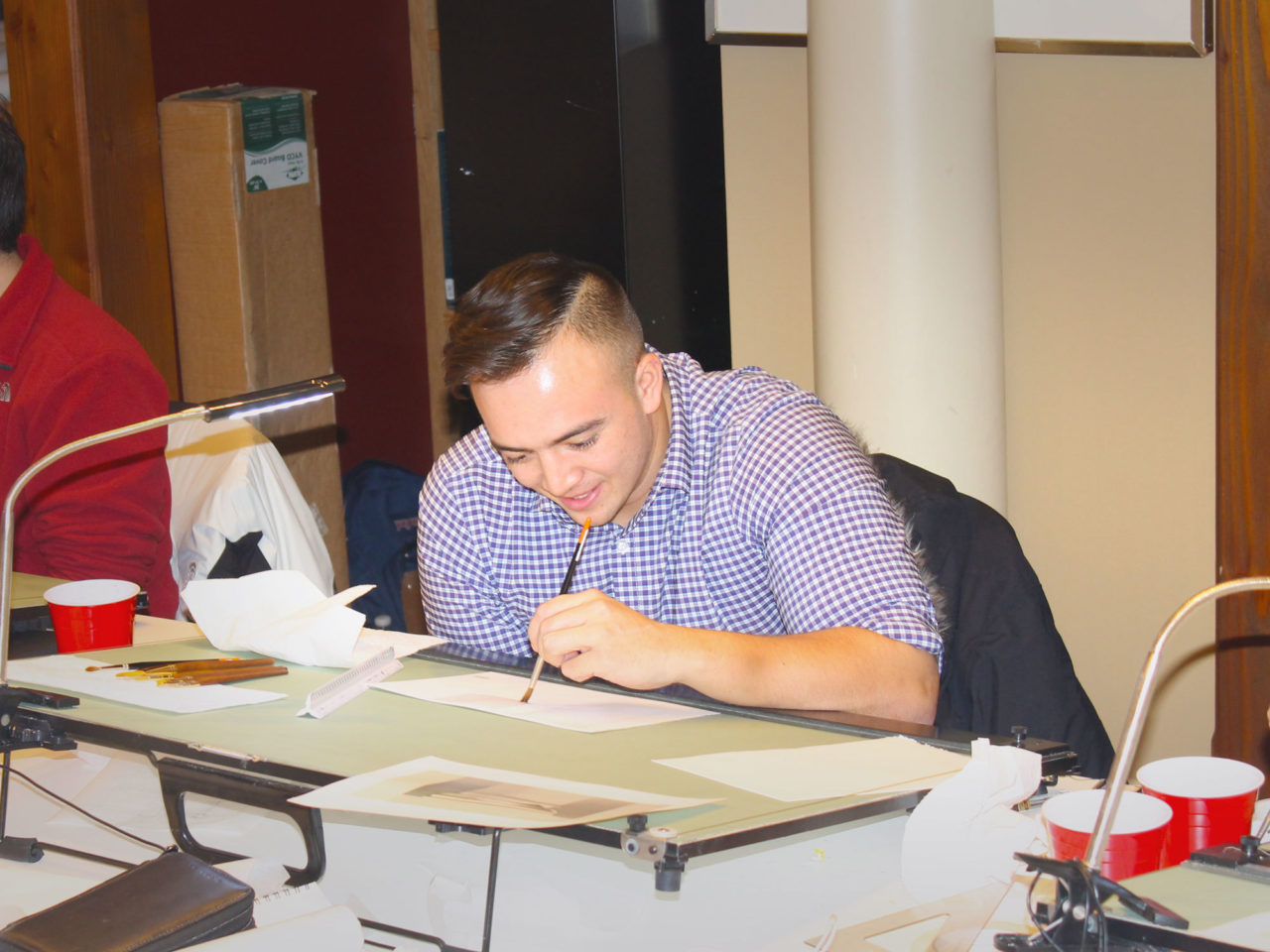 Tommy Vince participating in an Ink Wash Rendering session with Instructor David Genther